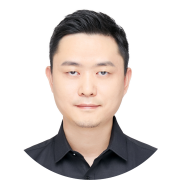 Professional headshot of an individual in a black shirt, neutral background, centered in the frame.