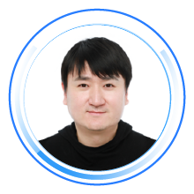 Professional headshot of an individual with dark hair, a black top, and a white background, encircled by blue digital graphics.